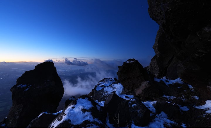 A spectacular view from a rocky area covered with snow at a high altitude