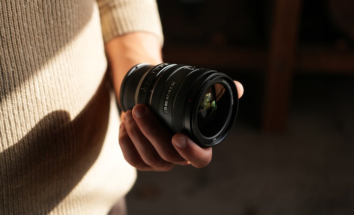 View of lens barrel held in user’s hand, showing the compact lens size